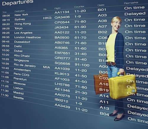 Composite image of young woman standing in front of departures board