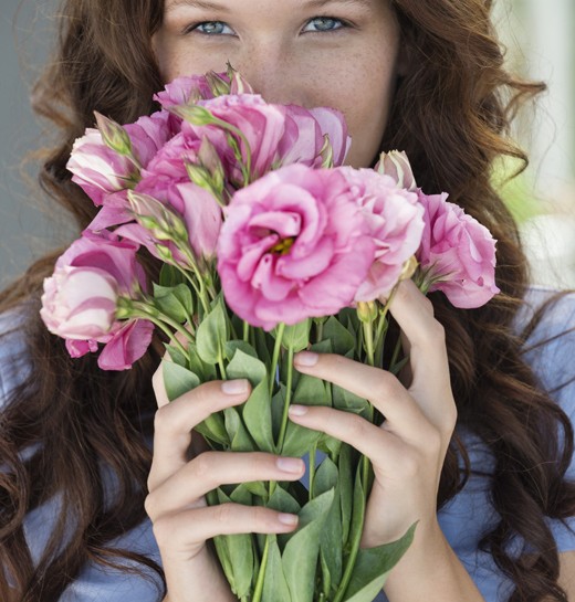 Portrait of a woman holding a bouquet of flowers