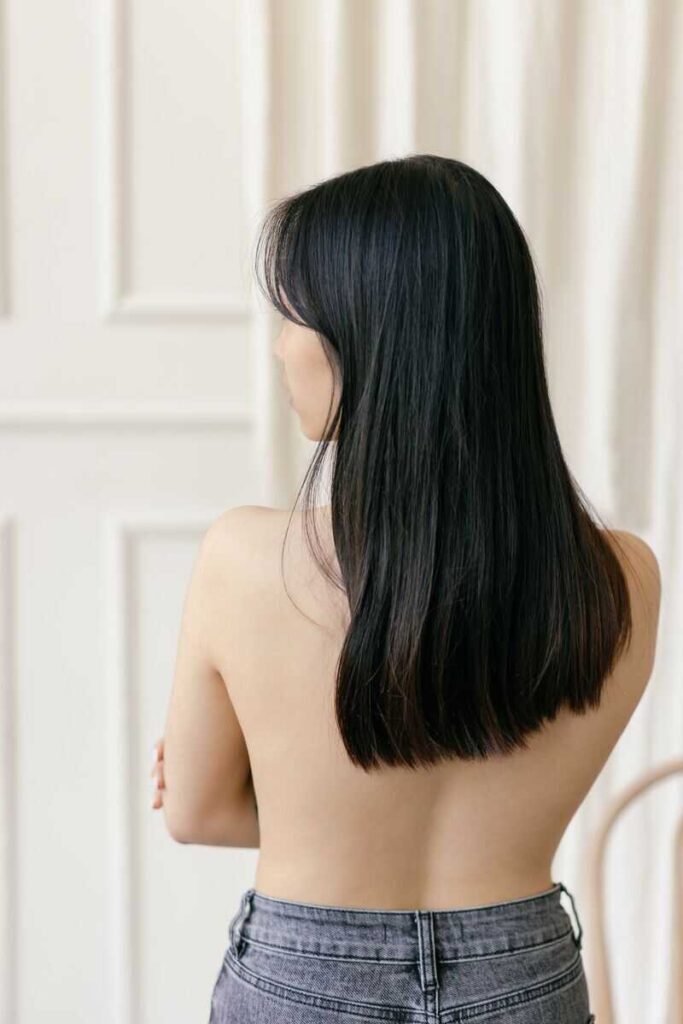 Ragazza di schiena con capelli scuri lunghi