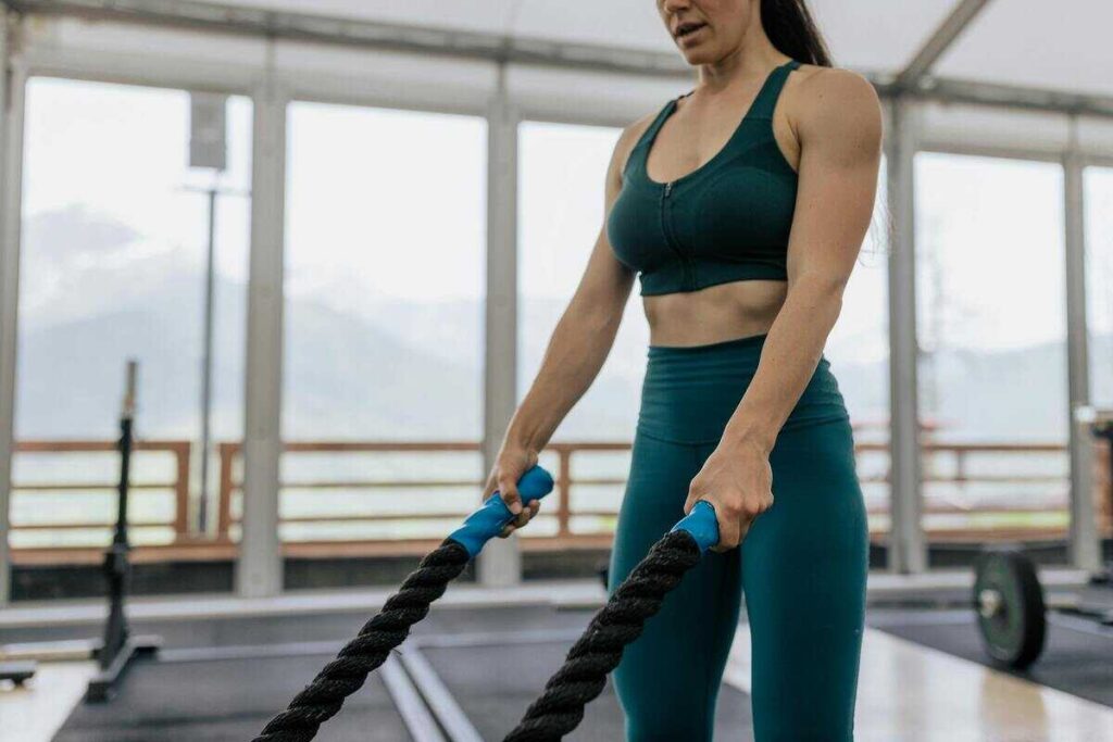 Donna che fa esercizi per braccia in palestra