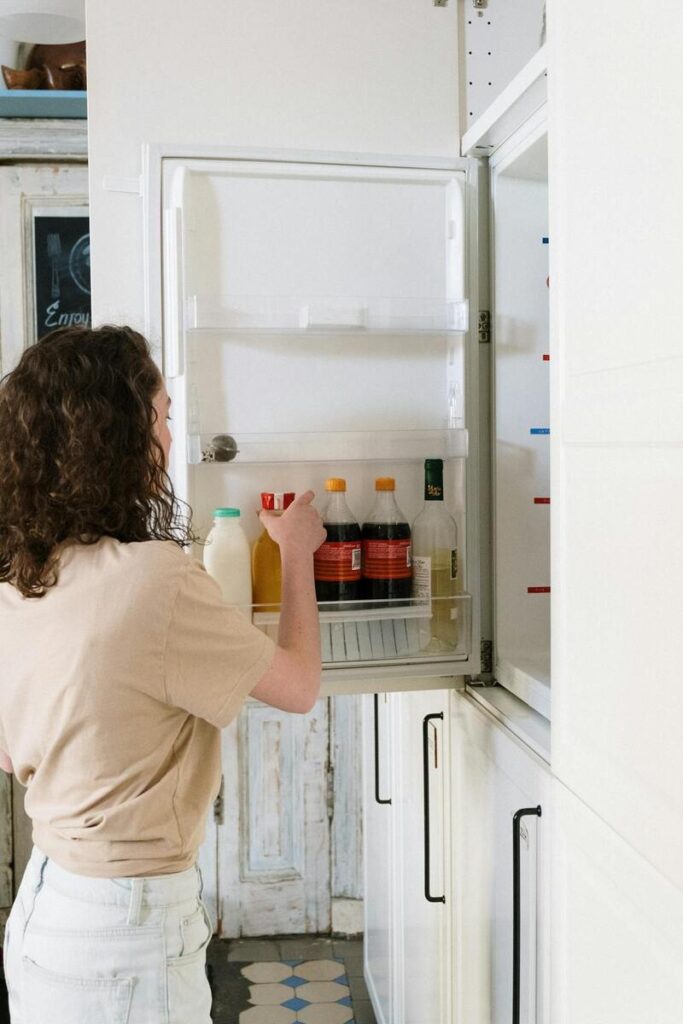 donna ripone il latte nel frigo