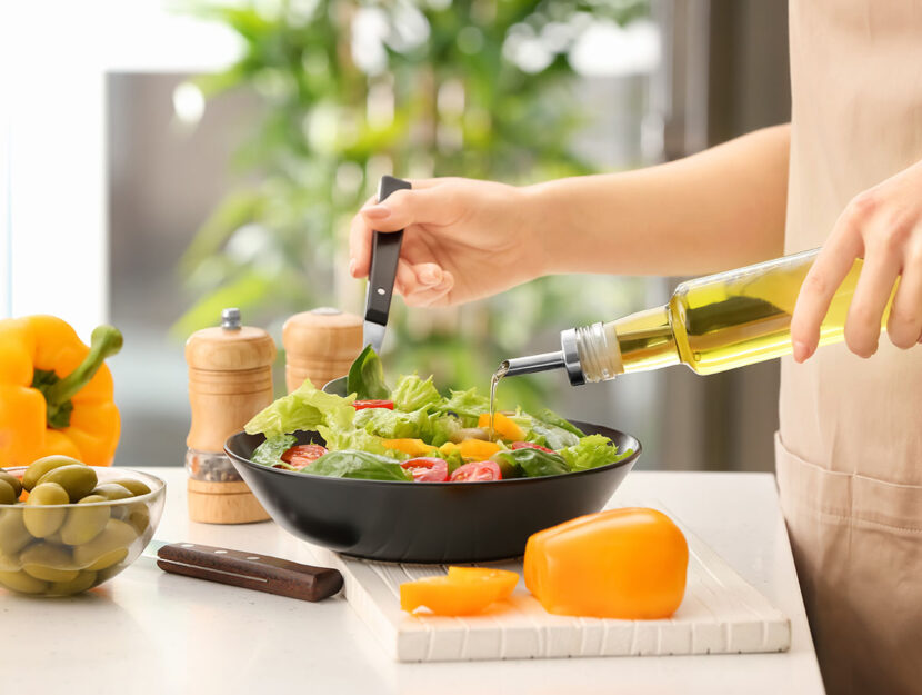 Donna prepara insalata olio cucina