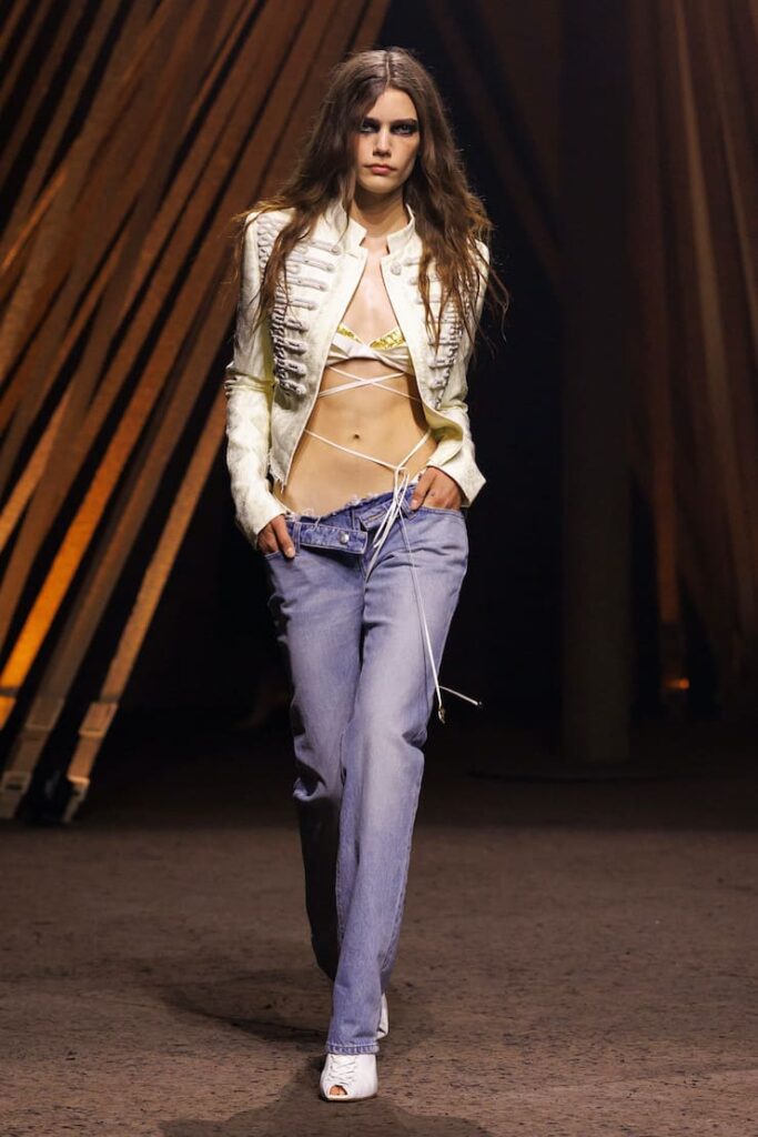 Modella alla sfilata McQueen con pantaloni a vita bassa