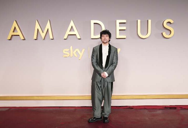 Il protagonista di amadeus davanti al backdrop alla presentazione