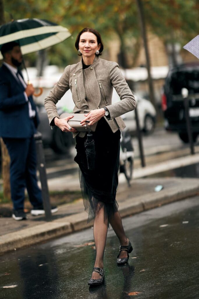 Donna con giacca Chanel, longuette e calze nere velate