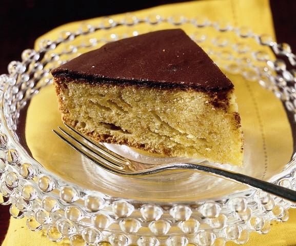 <p>Mescolate 70 g di zucchero a velo in una ciotola con 30 g di cacao amaro setacciato. Unite 2 o 3 cucchiai di acqua e mescolate: dovrete ottenere una crema abbastanza densa. Versatela al centro del dolce e, servendovi di una spatola, stendetela verso l'esterno. Un trucco: pareggiate la superficie della torta, quindi capovolgetela in modo da stendere la glassa sulla base: il risultato sarà una copertura più liscia e uniforme.</p>