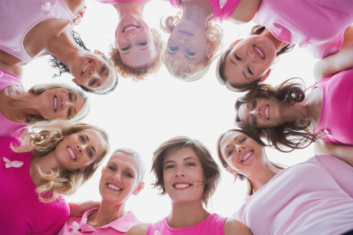 02 Apr 2013 --- Group of happy women in circle wearing pink for breast cancer --- Image by © Wavebreak Media Ltd./Corbis