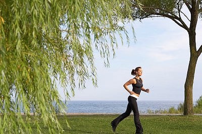 Woman Running in Park --- Image by © Radius Images/Corbis