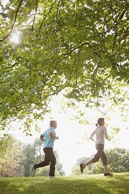 Woman Running in Park --- Image by © Radius Images/Corbis