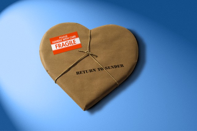 Heart shape wrapped in brown paper, return to sender --- Image by © James Nazz/Corbis