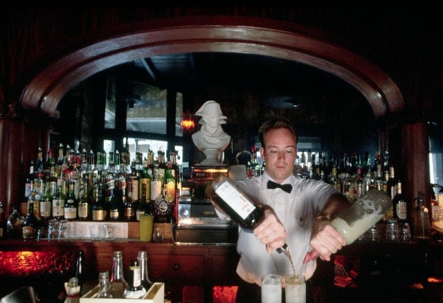 ca. 1980s-1990s, New Orleans, Louisiana, USA --- Bartender Ralph Groskoph mixes a "Pimm's Cup" cocktail at The Napoleon House. --- Image by © Philip Gould/Corbis