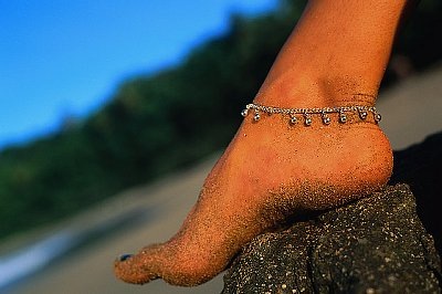 Tobago, Trinidad and Tobago --- Foot and Ankle Bracelet --- Image by © Jack Hollingsworth/Corbis
