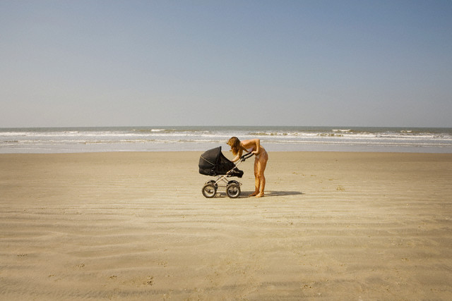 Woman checking on her baby --- Image by © Poppy Berry/Corbis