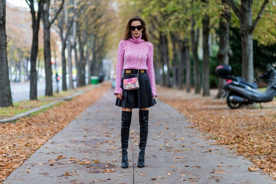 <p>Gonna di pelle nera a pieghe con un pullover fucsia</p>